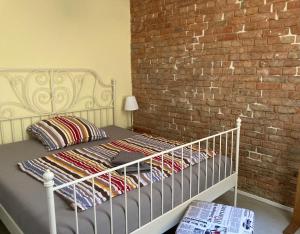 a bed in a room with a brick wall at SUITE-DREAMS LOFT - Innenstadt in Hannover