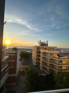 a view of a building with the sunset in the background at ELIZ Luxury Residence in Mamaia