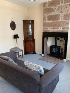 a living room with a couch and a fireplace at 17 Main Street in St Bees