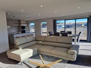 a living room with a couch and a table at Ahuru Mōwai in Lake Tekapo