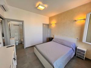 a bedroom with a large bed and a bathroom at Suite Riminese with Beach Service in Rimini +11 photos