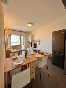 a kitchen with a table with two sinks and a refrigerator at Suite Riminese with Beach Service in Rimini