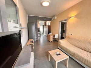 a living room with a couch and a table at Suite Riminese with Beach Service in Rimini