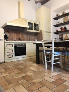 a kitchen with a table and a stove top oven at IRIS in Villa Guardia