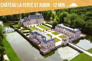 an aerial view of a large mansion on the water at Maison entière avec jardin - Comet Arena - Zenith in Olivet