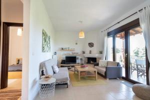a living room with a couch and a table at Serenity Cove, The Fox s Lair Hospitality in Agia Paraskevi