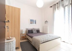 a small bedroom with a bed and a window at Serenity Cove, The Fox s Lair Hospitality in Agia Paraskevi