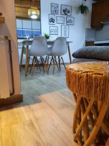 a dining room with a table and white chairs at mcastet, casita aranesa en el valle de aran in Bossost