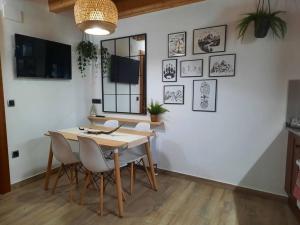 a dining room with a table and chairs at mcastet, casita aranesa en el valle de aran in Bossost