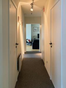 a hallway with a hallway leading to a living room at Parc & Dunes in Knokke-Heist