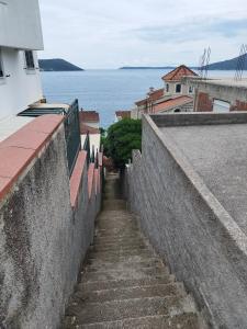 een trap naar een muur met water bij Nikolina Apartments Herceg Novi in Herceg-Novi