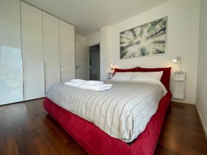 a bedroom with a large bed with two towels on it at La Dolce Vita Arco in Arco