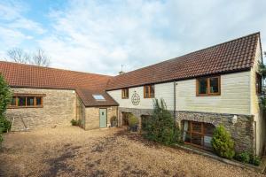 an exterior view of a house with a driveway at The West Barn near Bath, sleeps 24 and 2 hot tubs in Bristol