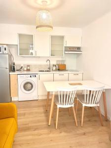 a kitchen with a table and two chairs and a sink at Appartement 30m2 cosy avec terrasse in Menton