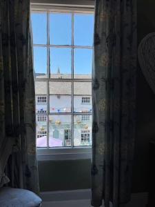 a window with a view of a building at Cosy 2 bed flat in Crickhowell in Crickhowell