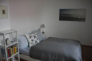 a bedroom with a bed and a book shelf at Traumhafte Etagenwohnung in Günderzeitvilla in Dresden