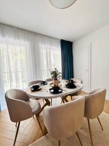 a dining room with a table and chairs at Apartament Zielony Pobierowo Baltic Apartments in Pobierowo