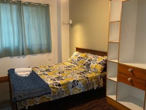 a small bedroom with a bed and a book shelf at THE-SOMERSET INN & RESTAURANT in Iloilo City