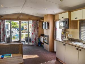 an rv kitchen with a view of a porch at Bluebird in Prestatyn