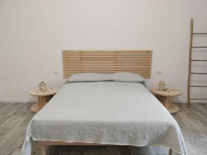 a bedroom with a large bed with two tables at Il Regno delle due Sicilie in Riposto