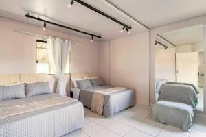 a bedroom with two beds and a mirror at CASA SERRA CATARINENSE in Rio Rufino