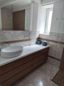 a bathroom with a sink and a mirror at Suite in centro in Galatina