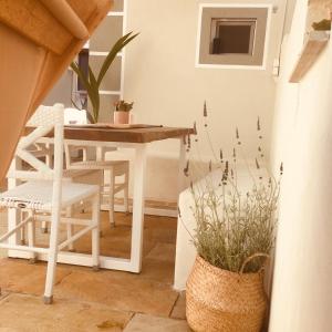 a dining room with a table and chairs at Babushka Apartments in Olympiada