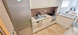 a small kitchen with a sink and a stove at STAY HOME GETXO Metro and Beach in Getxo