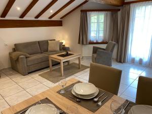 a living room with a couch and a table at Apartments Arcadia in Saas-Grund