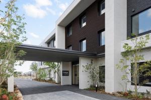 an external view of a building with a walkway at Fairfield by Marriott Okayama Tsuyama in Tuyama