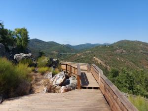 a wooden bridge with a view of the mountains at Casa do Pastana in Ansião