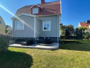 a house with a hot tub in the backyard at Villa Rydholm 15 minutes from Gothenburg Center in Gothenburg
