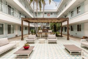 an outdoor patio with couches and tables in a building at East Village Arts District, King Suite with Sofa Bed NRP23-01221 in Long Beach