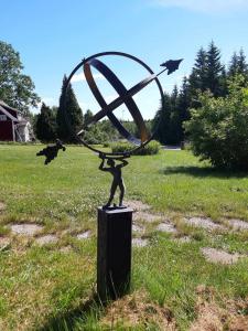 a statue of a person with birds flying around it at Lunden in Vittaryd