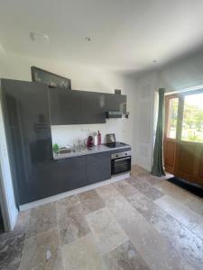 a kitchen with a sink and a stove at L'Echo de la nature in Sasseville