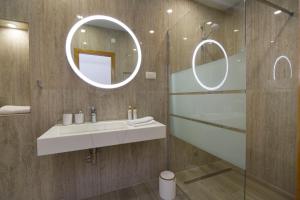 a bathroom with a sink and a mirror at Apartments Marija in Brna