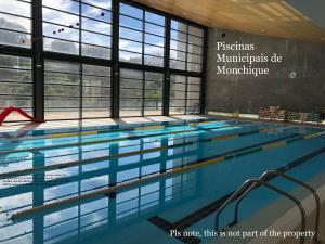 a large swimming pool in a building at Casa Lilia in Monchique