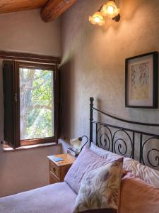 a bedroom with a bed and a window at Il Nascondiglio - The Hideaway in Amandola