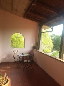 a table and chairs in a room with a window at Manuel suites in Pianella