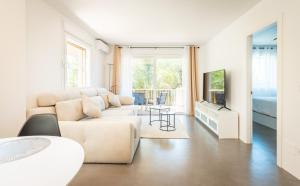 a white living room with a couch and a table at Apartment Puerto Banus Marbella in Marbella