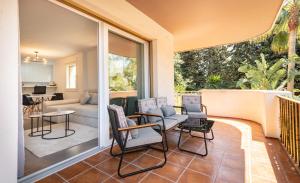 a patio with chairs and a table and a couch at Apartment Puerto Banus Marbella in Marbella