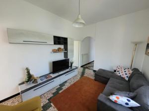 a living room with a couch and a flat screen tv at Ca' du Bertu in San Bartolomeo