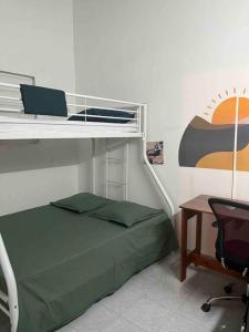 a bedroom with a bunk bed and a desk at La Verdure in Petit-Bourg