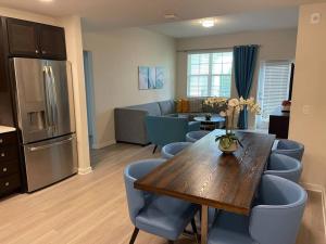 a dining room with a table and chairs and a kitchen at Vista Cay Condo, next to convention center, See World, Disney 3 in Orlando