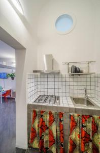a kitchen with a sink and a stove top oven at CASA NINNI in Catania