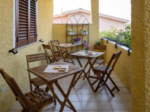 a wooden table and chairs on a patio at B&B Da Laura San Teodoro in San Teodoro
