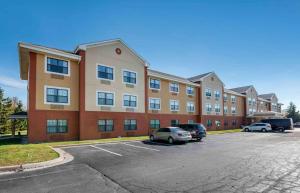 a large building with cars parked in a parking lot at Extended Stay America Suites - Fort Wayne - South in Fort Wayne