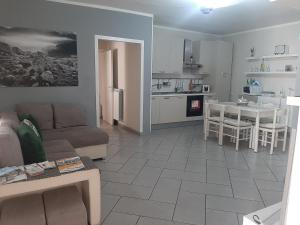 sala de estar y cocina con sofá y mesa en Holiday House NELLINA, en Boscoreale