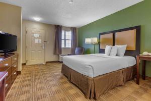 a hotel room with a large bed and a flat screen tv at Extended Stay America Suites - El Paso - Airport in El Paso