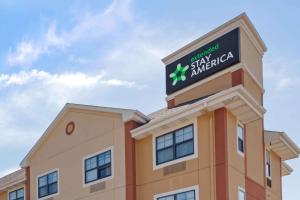 a building with a sign on top of it at Extended Stay America Suites - Dallas - Greenville Avenue in Dallas